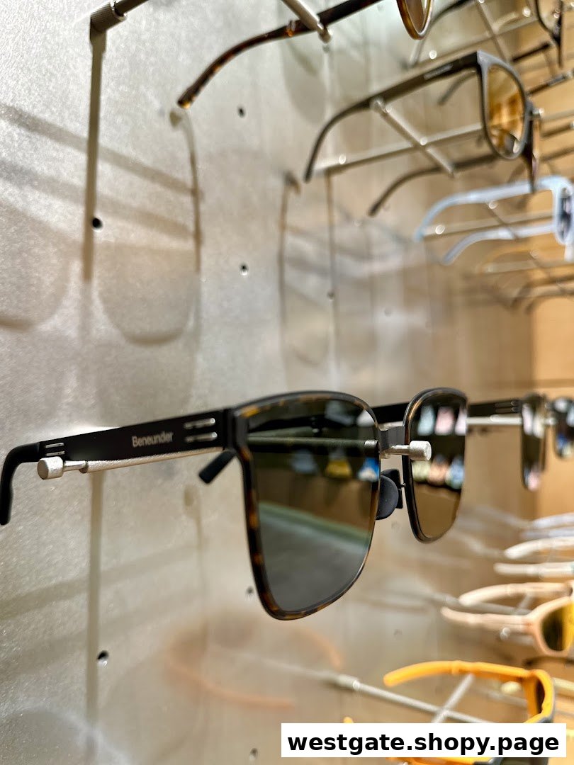 Close-up of stylish Beneunder sunglasses displayed on a wall rack.
