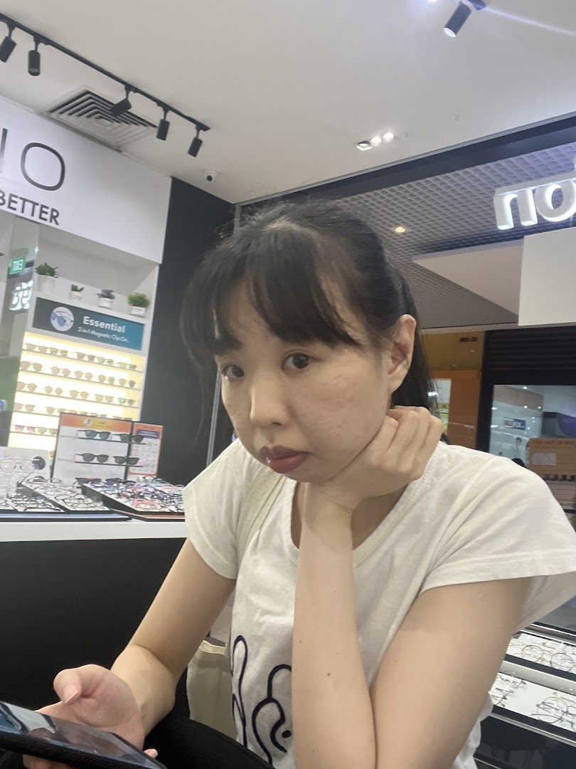 A customer browsing eyewear displays inside Better Vision, featuring magnetic clip-on options.