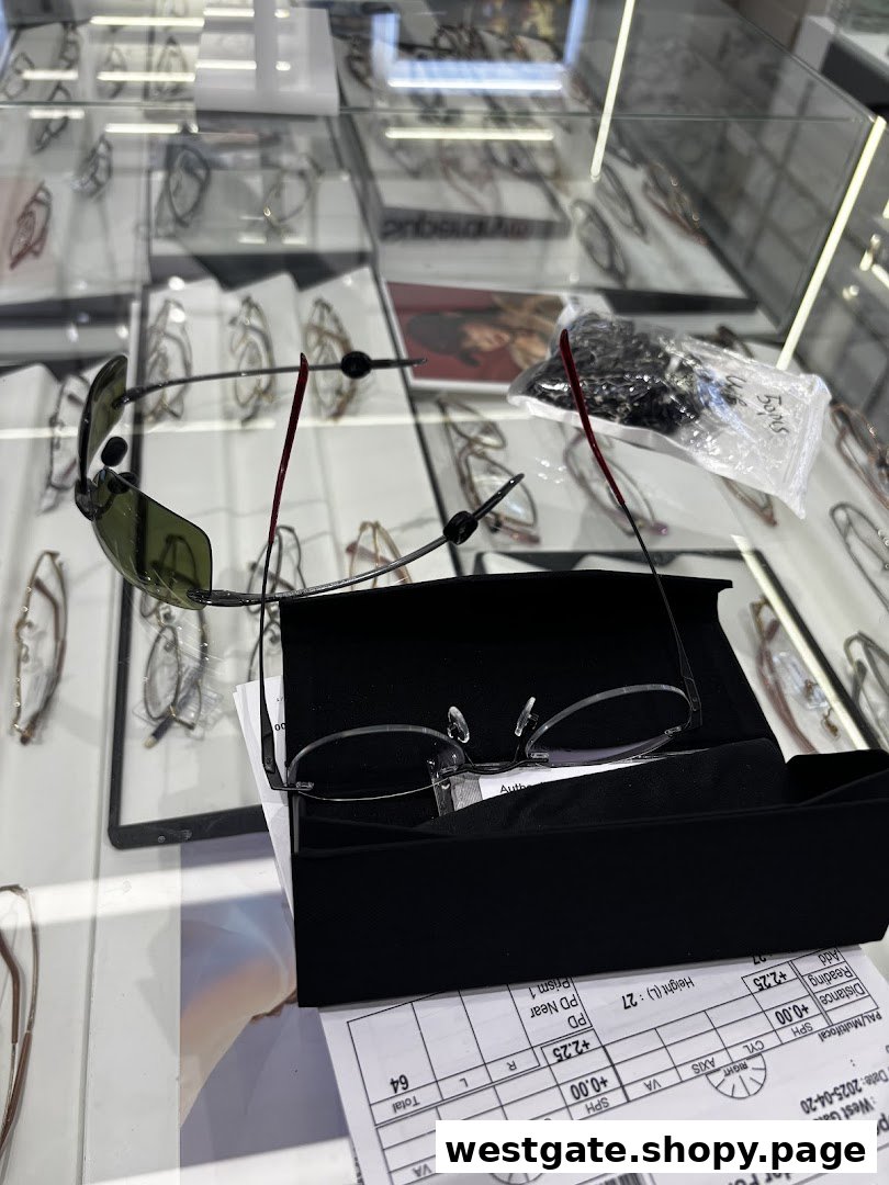 A close-up view of eyeglasses and sunglasses displayed in a modern optical shop, with a spectacle order form visible.