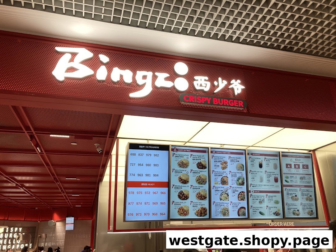 A vibrant red shop front of Bingz Singapore with digital menu boards displaying crispy burgers and sides.
