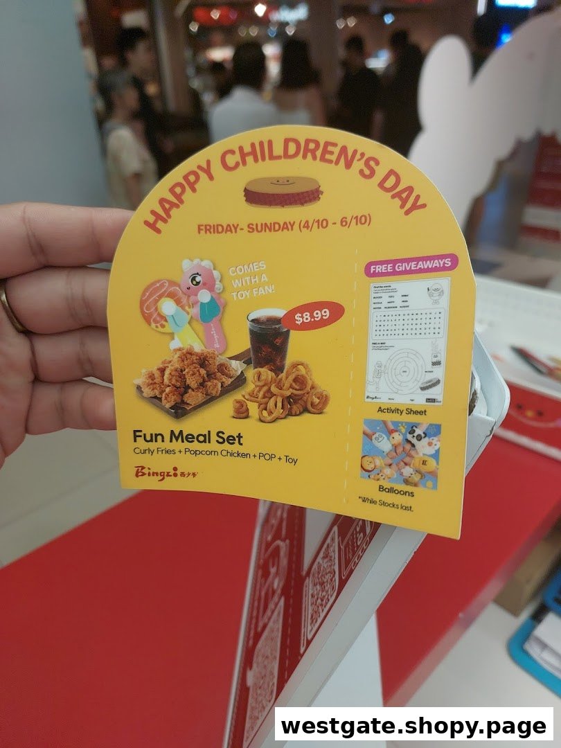 A promotional standee for Bingz's 'Happy Children's Day' Fun Meal Set, featuring food and toys.