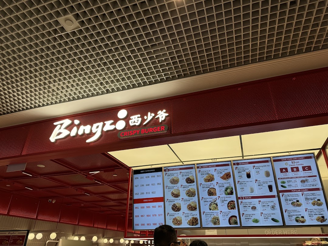 Interior view of Bingz Singapore, showcasing its vibrant red branding, menu boards, and order counter.