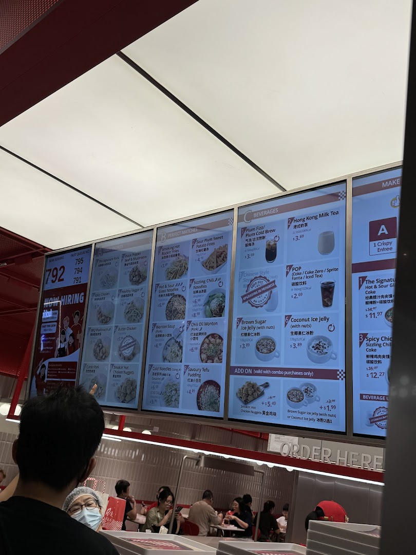 A digital menu board displaying a variety of Chinese dishes, sides, beverages, and combo meals.