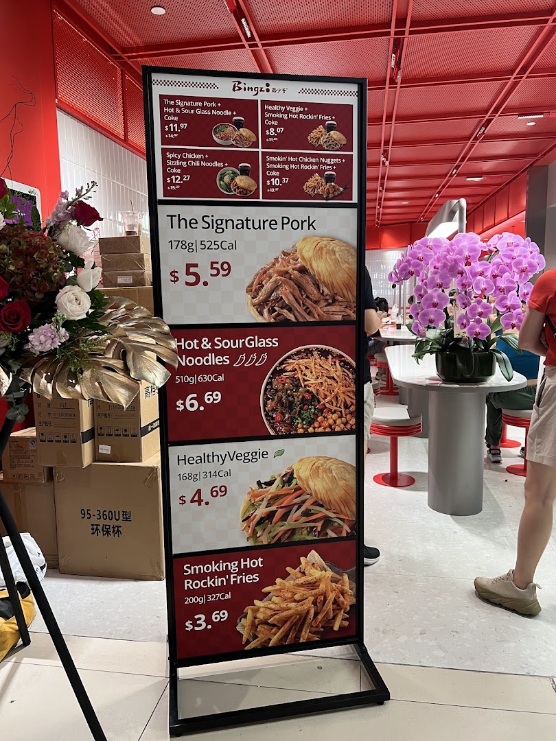 A prominent menu board displaying various food items and combos with prices at Bingz Singapore.