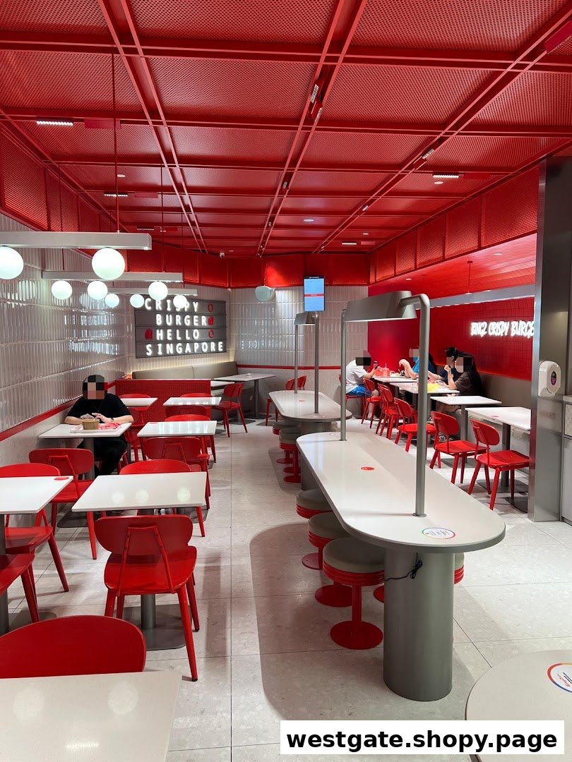 Vibrant red and white interior of Bingz Singapore, featuring various seating arrangements and customers dining.