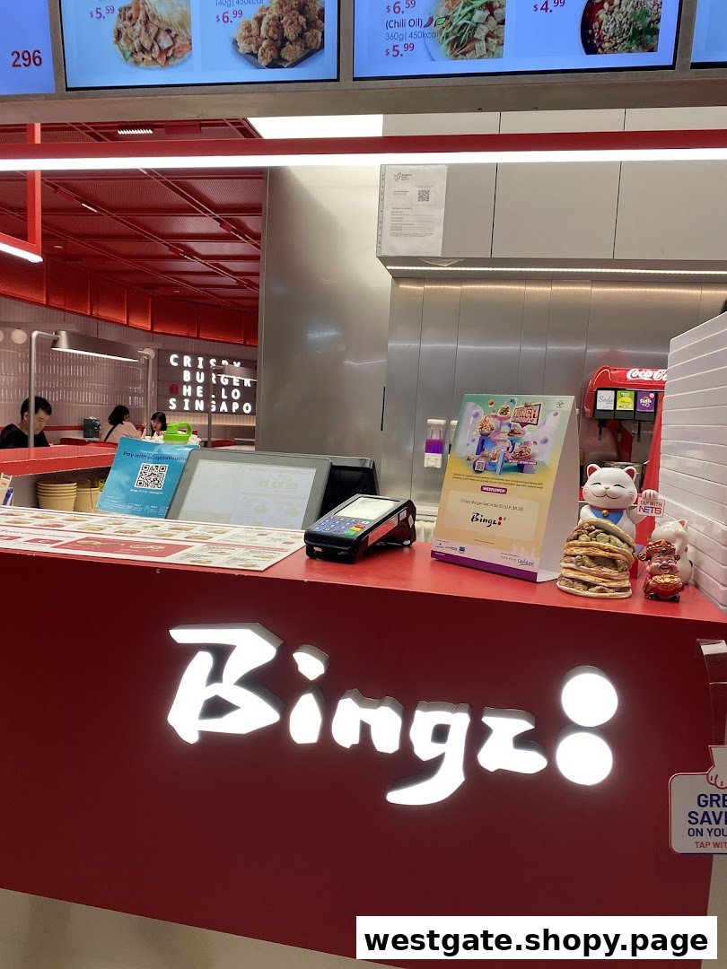 A vibrant red counter with the illuminated 'Bingz' logo, payment terminal, and digital menu screens in the background.