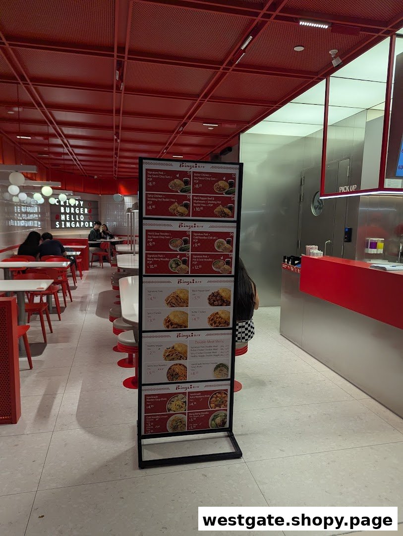 A clear display of Bingz Singapore's menu items and prices on a stand within the vibrant red-themed shop.