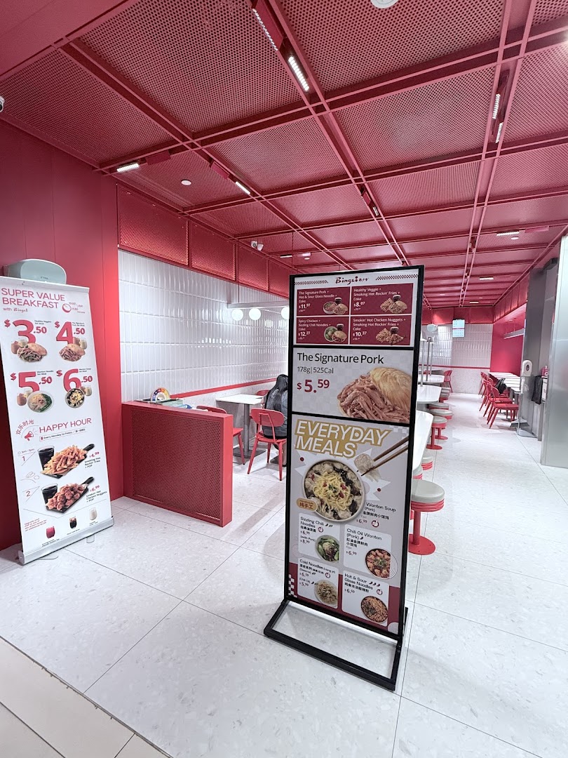 Interior view of Bingz Singapore, featuring vibrant red decor, seating, and prominent menu displays.