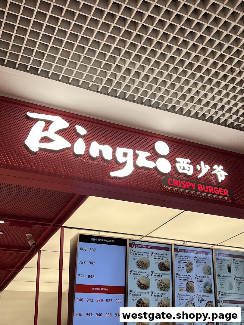 A vibrant shot of Bingz Singapore's counter, featuring its illuminated sign, digital order screen, and menu.