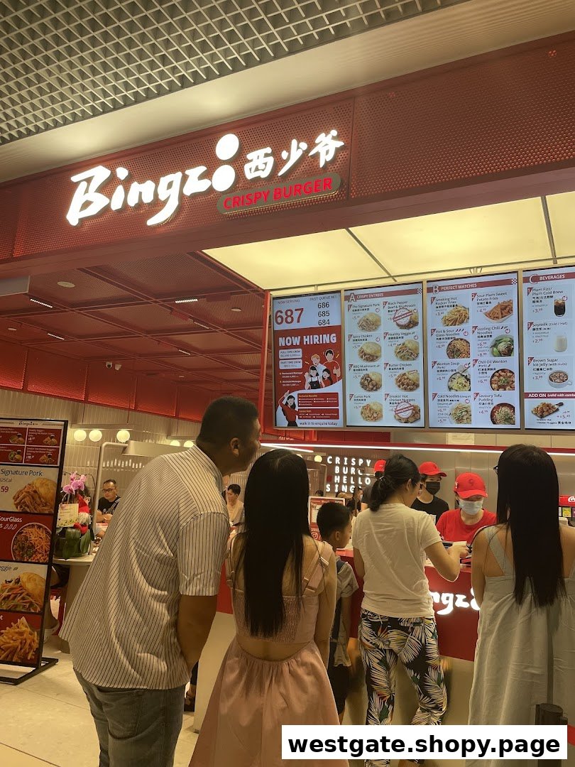Customers queueing at the counter of Bingz Crispy Burger, with menu boards displaying food and beverage options.