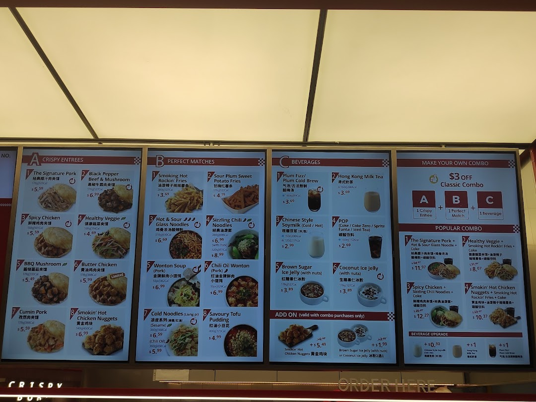 A brightly lit digital menu board displaying various food and beverage options with prices and combo deals.