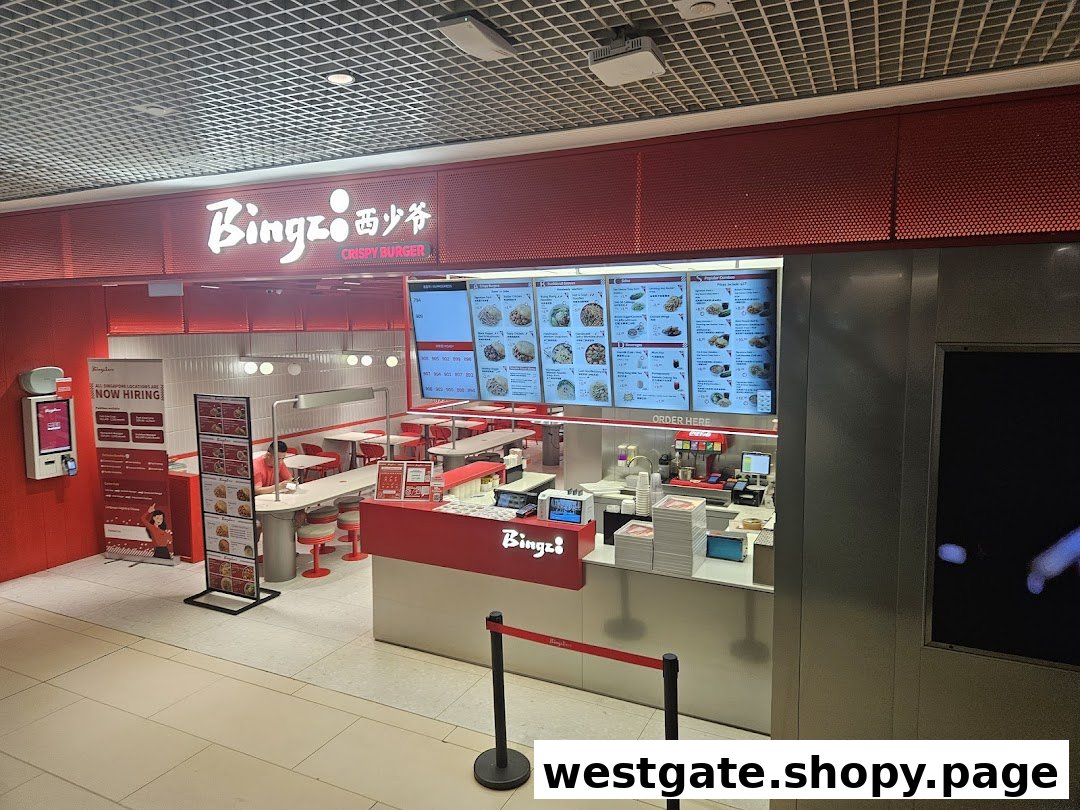 The vibrant red and white interior of Bingz Singapore, featuring an ordering counter, digital menus, and seating.