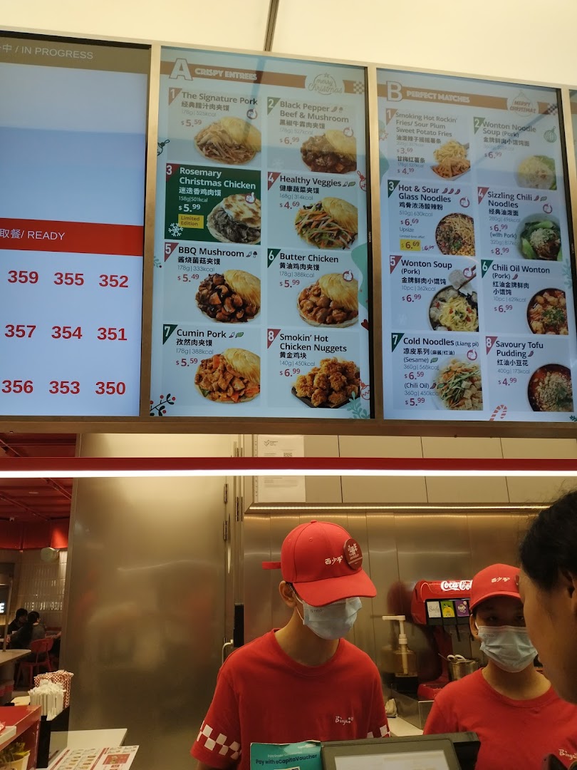 A clear view of Bingz Singapore's menu board featuring crispy entrees and perfect matches, with staff at the counter.