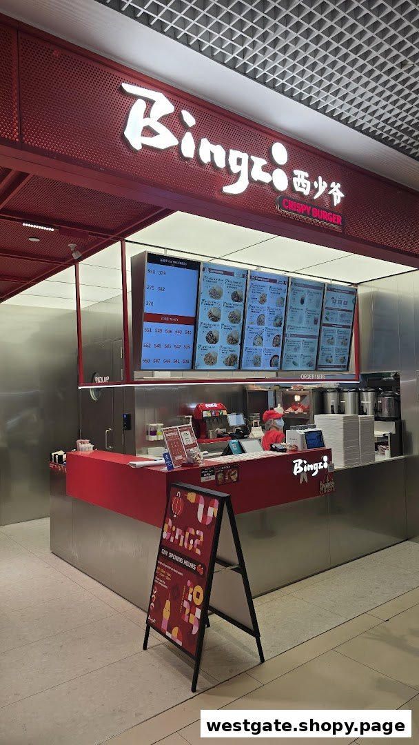 A vibrant red counter and digital menu boards at Bingz Singapore, showcasing their modern fast-casual setup.