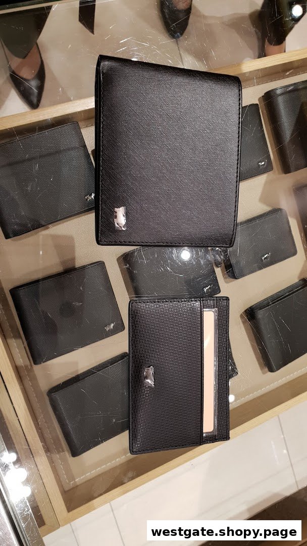 A display of various black leather wallets and cardholders from Braun Büffel, featuring the brand's iconic buffalo logo.