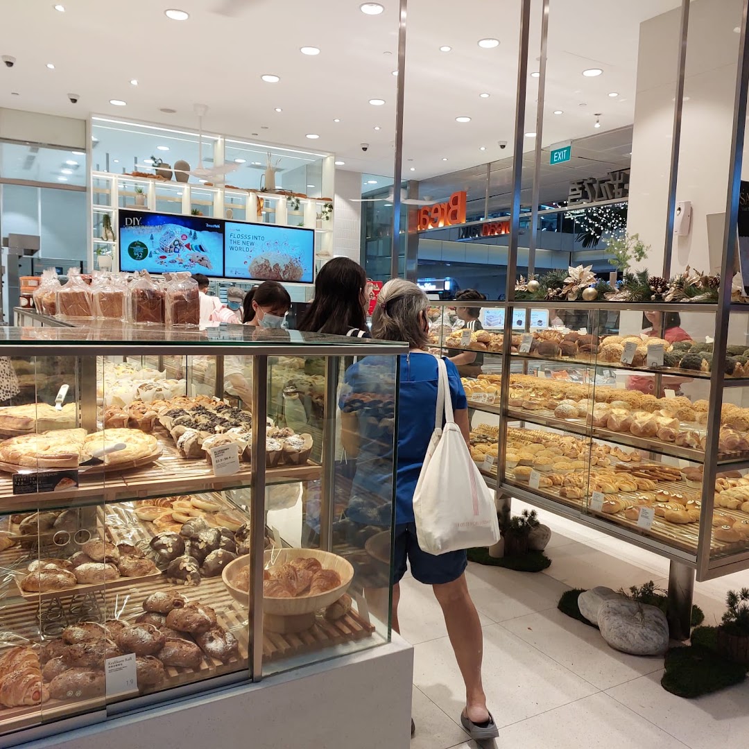 Customers browse a wide selection of freshly baked breads and pastries inside BreadTalk Westgate.