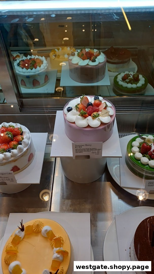 A vibrant display case showcasing a variety of beautifully decorated cakes at BreadTalk.