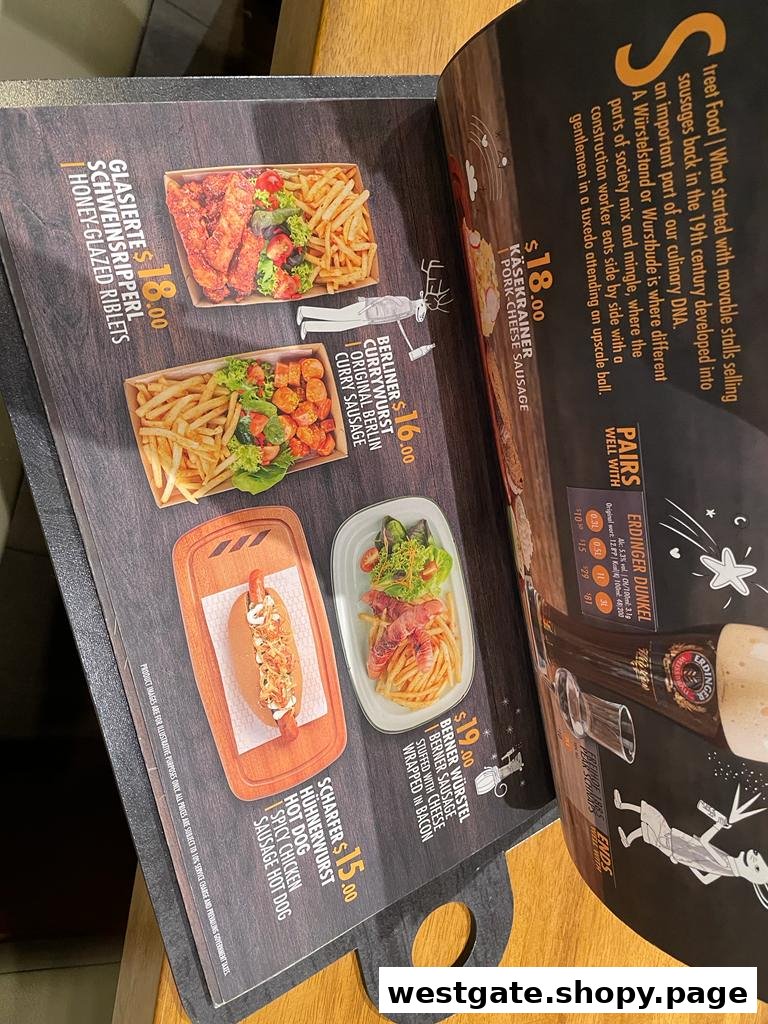 A page from a German restaurant menu showcasing various street food items and beer pairings.