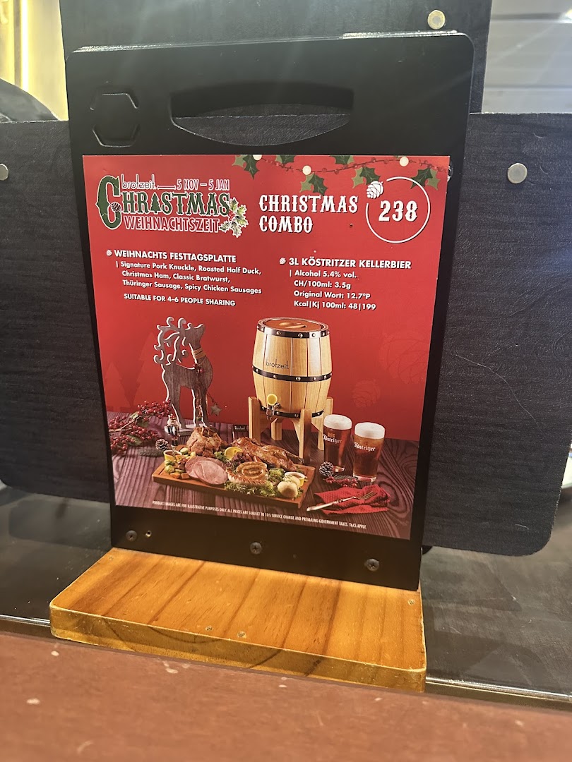 A promotional display for Brotzeit's Christmas Combo featuring a festive platter and beer.