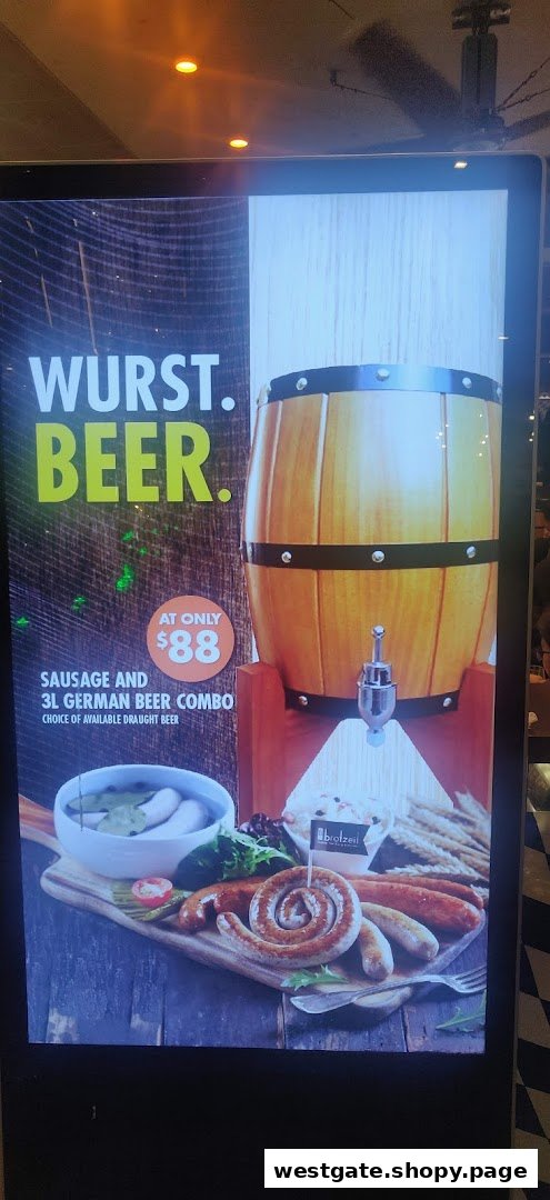 A digital display advertising a 'Wurst. Beer.' combo with sausages, a beer barrel, and an $88 price.