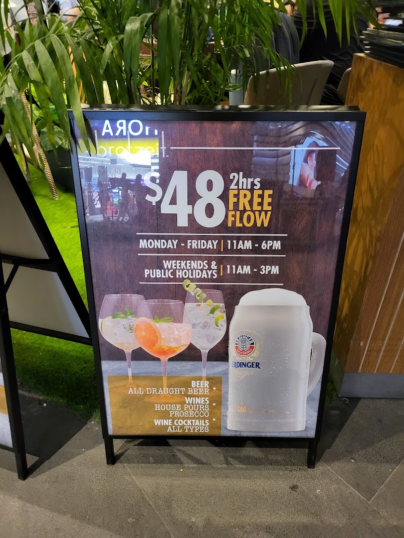 A promotional A-frame sign for Brotzeit's $48 free-flow drinks offer with timings.