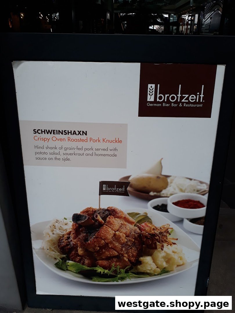 A promotional display board featuring Brotzeit's Crispy Oven Roasted Pork Knuckle (Schweinshaxn) with description.