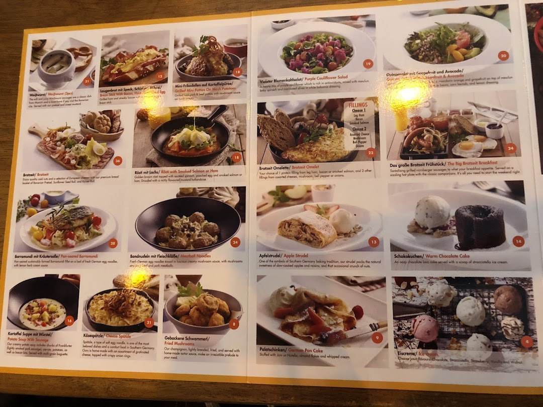A comprehensive menu displaying various German dishes, including appetizers, main courses, salads, and desserts.