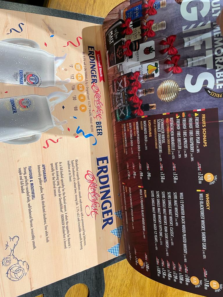A detailed menu page featuring German beers, schnapps, whiskies, liqueurs, rum, and gin.