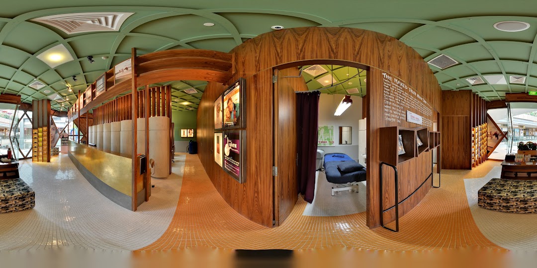 A panoramic view of Browhaus Westgate's modern interior, featuring a reception area, product displays, and a treatment room.