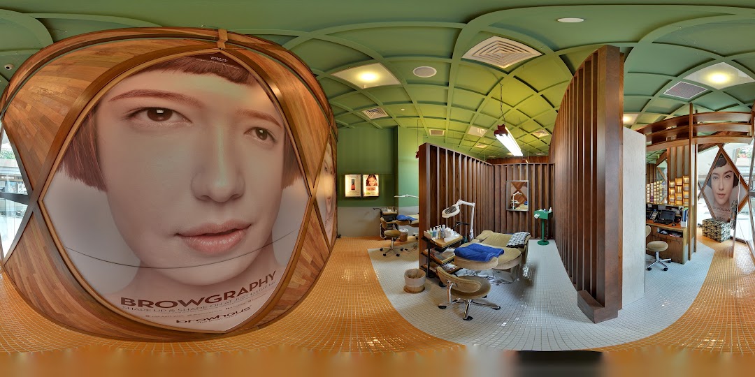 A panoramic view of Browhaus Westgate's modern interior, featuring treatment stations and a large 'Browgraphy' display.