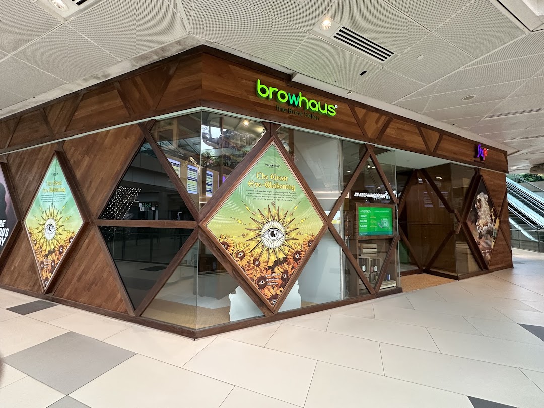 The exterior of Browhaus Westgate, a brow salon, featuring a unique wooden and glass facade.