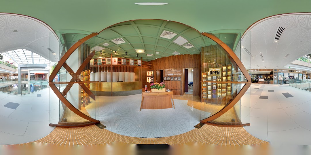A panoramic view of Browhaus Westgate's unique curved shop entrance and interior from the mall walkway.