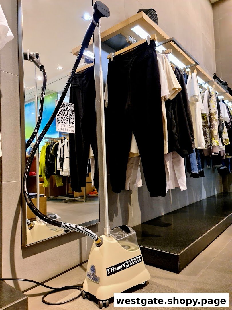 An interior view of a Calvin Klein store showcasing clothing racks, a mirror, and a garment steamer.