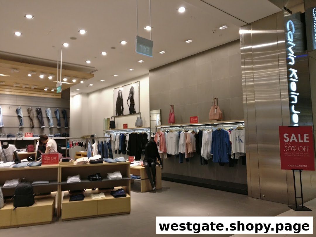 Interior view of a Calvin Klein store showcasing clothing displays and a prominent sale sign.