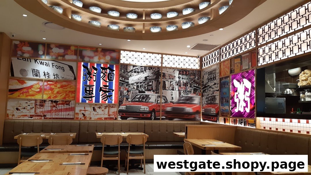 Interior view of Canton Paradise Noodle Congee House featuring Hong Kong-themed wall art and wooden dining tables.