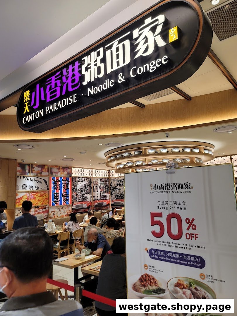 An inviting interior shot of Canton Paradise Noodle & Congee House, bustling with diners and featuring a promotional standee.