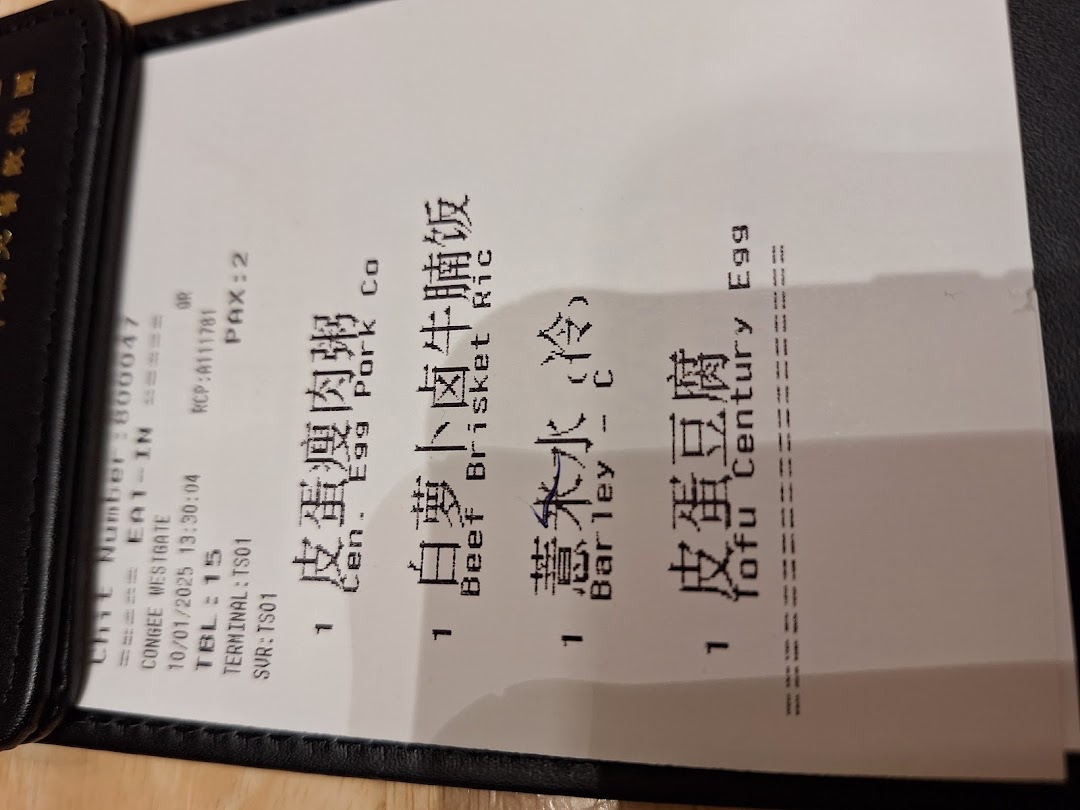 A close-up of a restaurant order slip detailing selected congee, rice, and side dishes.
