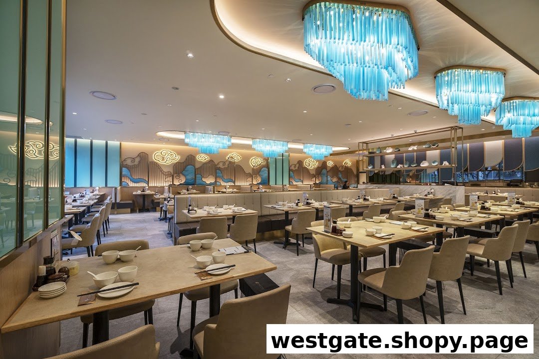 A spacious and elegantly decorated dining area with numerous tables, comfortable seating, and modern lighting fixtures.
