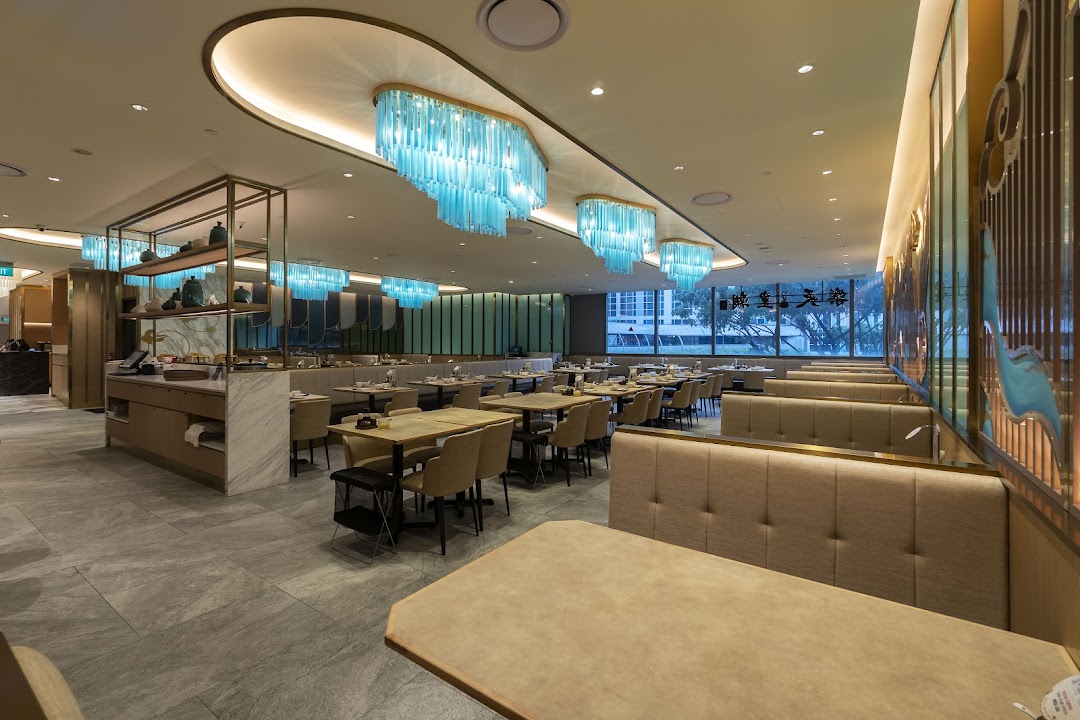 A spacious and elegantly designed restaurant interior with modern lighting and comfortable seating.
