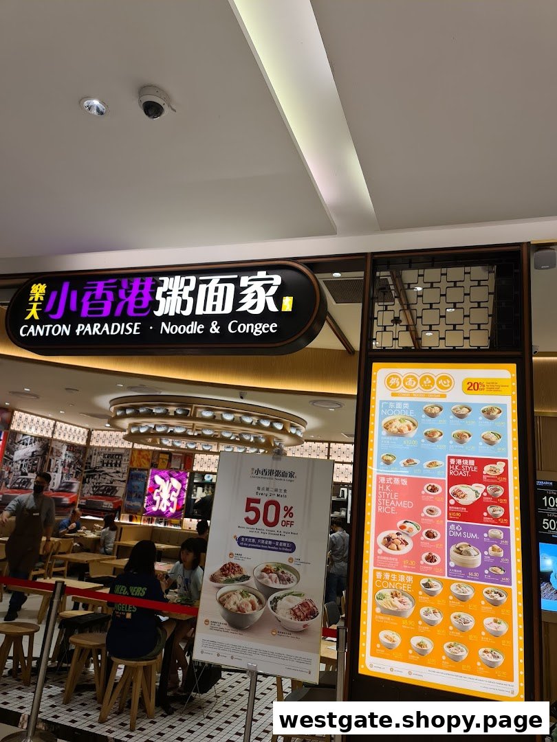 The vibrant entrance of Canton Paradise Noodle & Congee House, featuring its illuminated sign and a digital menu display.