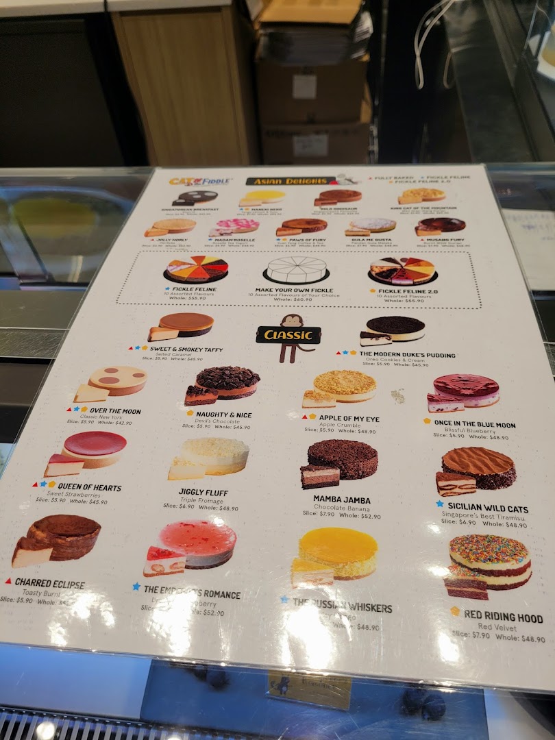 A detailed menu board from Cat & the Fiddle Cakes, showcasing various cheesecake flavors and prices.