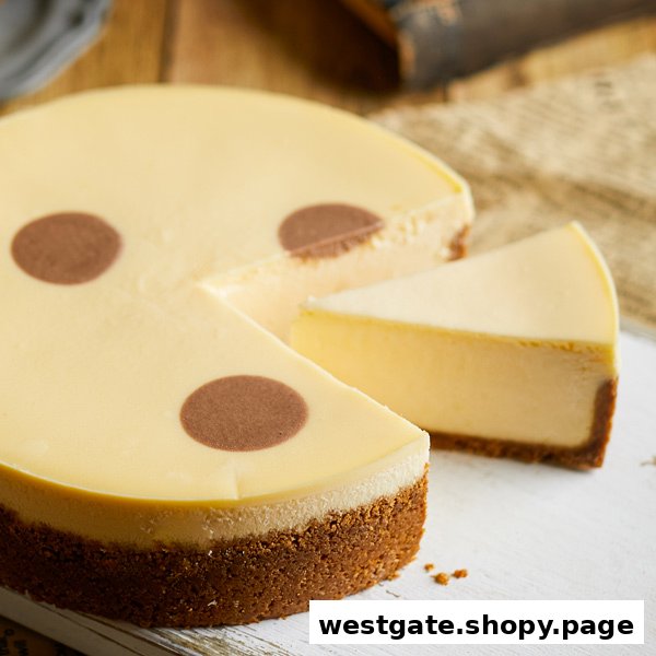 A creamy cheesecake with a slice removed, showcasing its rich texture and crumbly base.