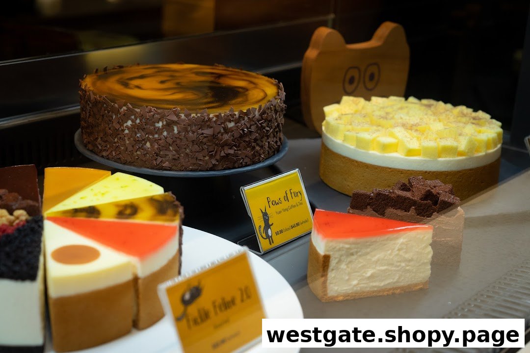 A vibrant display of delicious whole and sliced cakes in a dessert shop's showcase.