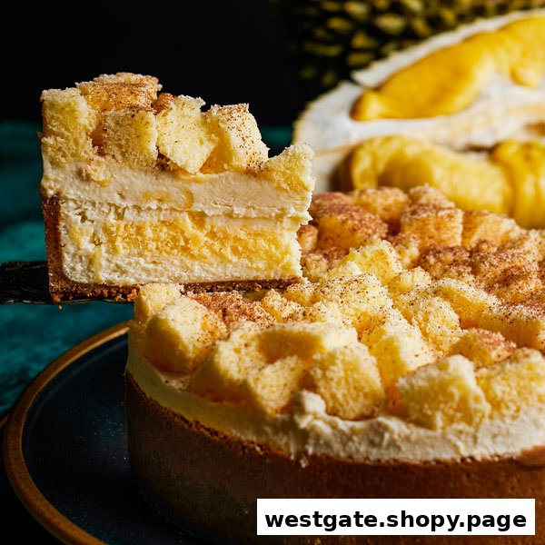 A delicious slice of multi-layered durian cake being served from a whole cake.