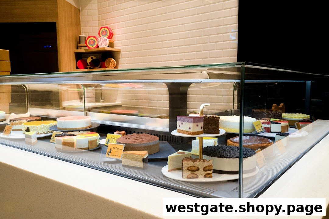A vibrant display case showcasing a variety of delicious whole cakes and slices at Cat the Fiddle Cakes.