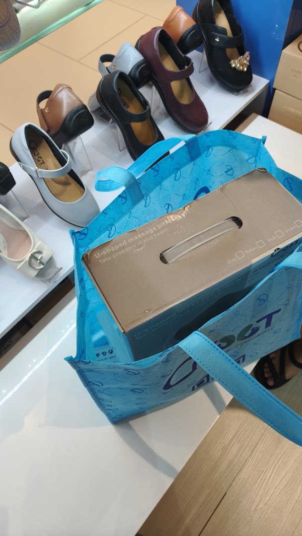 An interior shot of CFOOT showcasing various comfortable women's shoes on display, with a shopping bag.