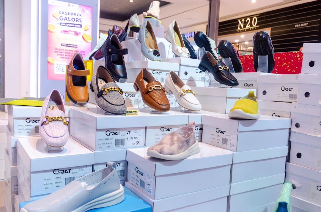 A vibrant display of stylish women's shoes and shoe boxes from CFOOT, showcasing various designs.