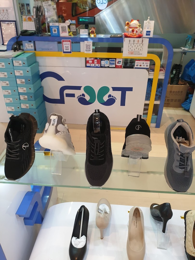 An interior view of CFOOT shoe store, showcasing a variety of footwear on display shelves.