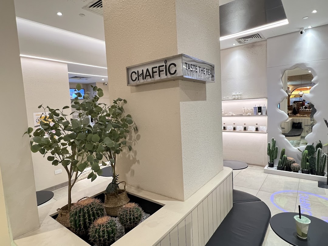 An interior view of Chaffic Westgate, featuring modern decor, plants, and seating areas.
