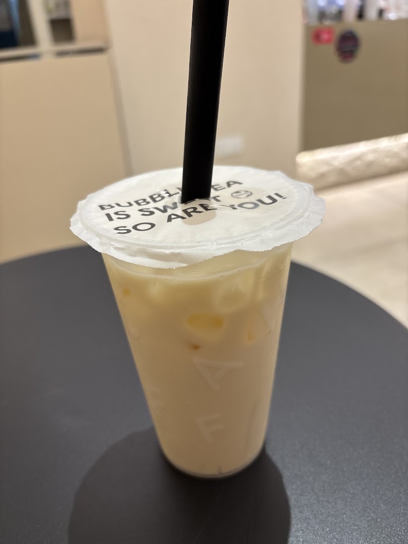 A close-up of a creamy bubble tea from Chaffic Westgate with a playful message on the lid.